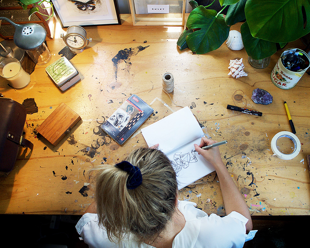 Cara Sanders aka Owlet Art drawing in her home studio