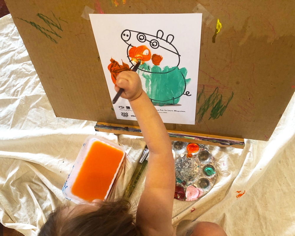 Birds eye view of child painting Peppa Pig - Cork & Chroma Blog