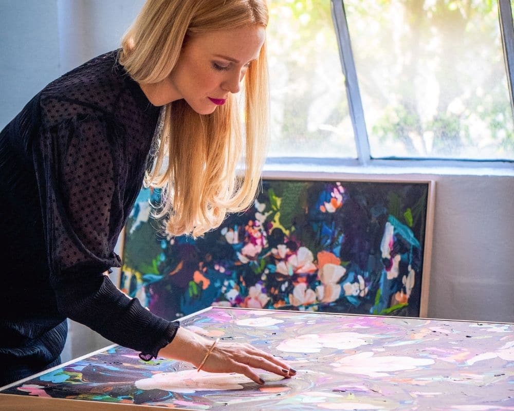 Melbourne artist, Chloé Newby, with her 'Midnight Magnolias' painting collection.