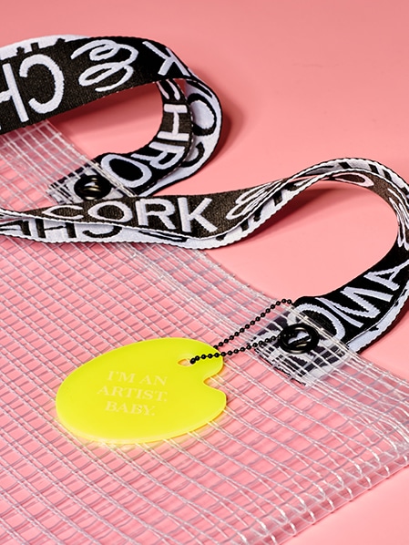 Cropped detail shot of PVC&C Tote Bag by Cork & Chroma with neon yellow Smol Palette Keychain