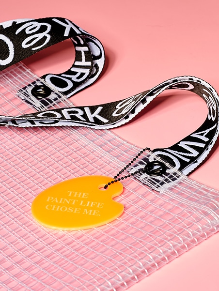Cropped detail shot of PVC&C Tote Bag by Cork & Chroma with neon orange Smol Palette Keychain