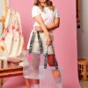 Model holding two PVC&C Tote Bag by Cork & Chroma with neon keychain