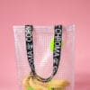 A bunch of bananas in PVC&C Tote Bag by Cork & Chroma with neon keychain