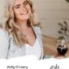 Holly O'Leary Wine Specialist at Rob Dolan Wines sitting with a glass of red wine